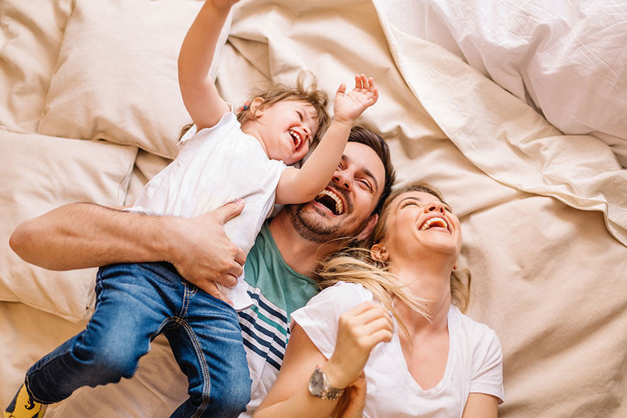 Header - Happy Family In Bed